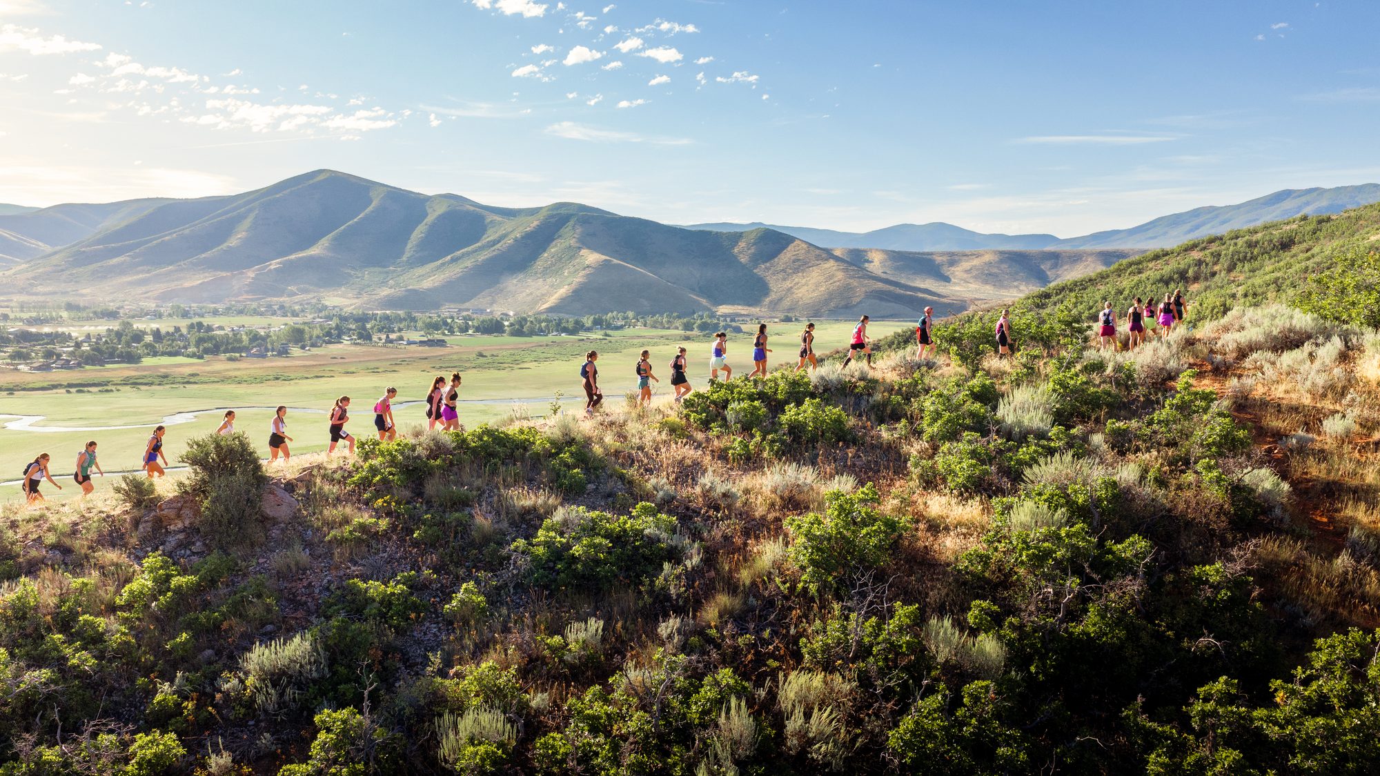 A line of Mamele Mountains runners climbing a ridge above the Heber valley.